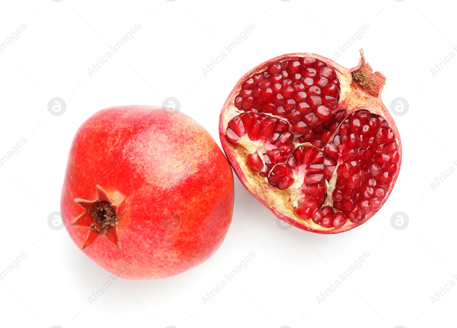 Photo of Whole and half of fresh pomegranates isolated on white, top view