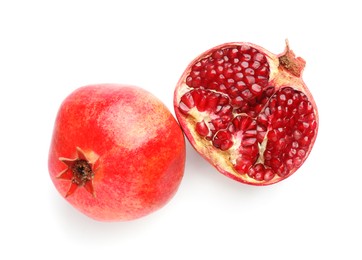 Photo of Whole and half of fresh pomegranates isolated on white, top view