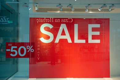 Siedlce, Poland - July 26, 2022: Sale sign on red stand in fashion store at shopping mall. Seasonal discount offer