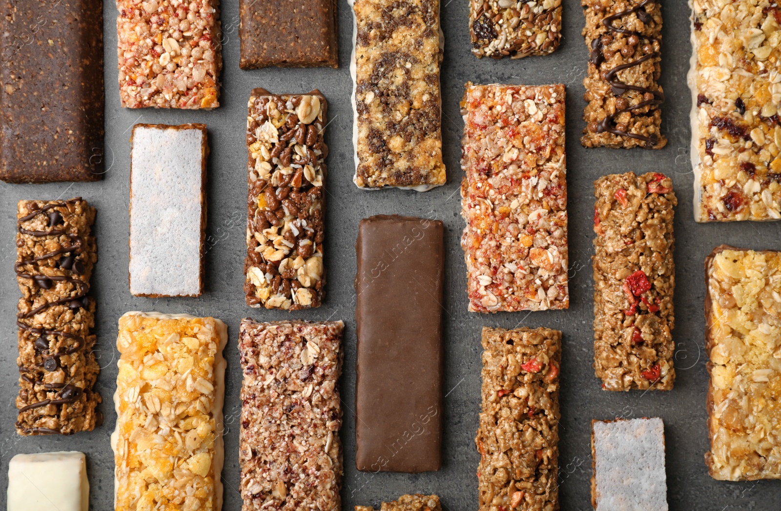 Photo of Flat lay composition with protein bars on grey background