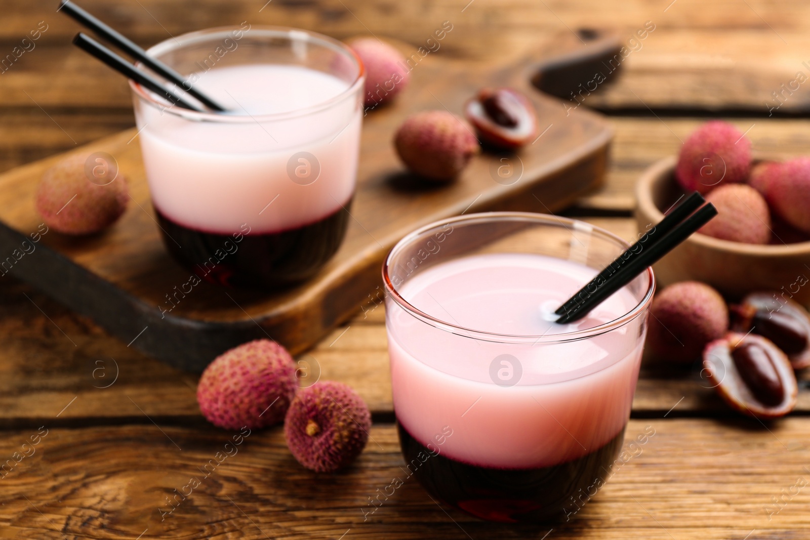 Photo of Tasty lychee cocktail on wooden table, closeup