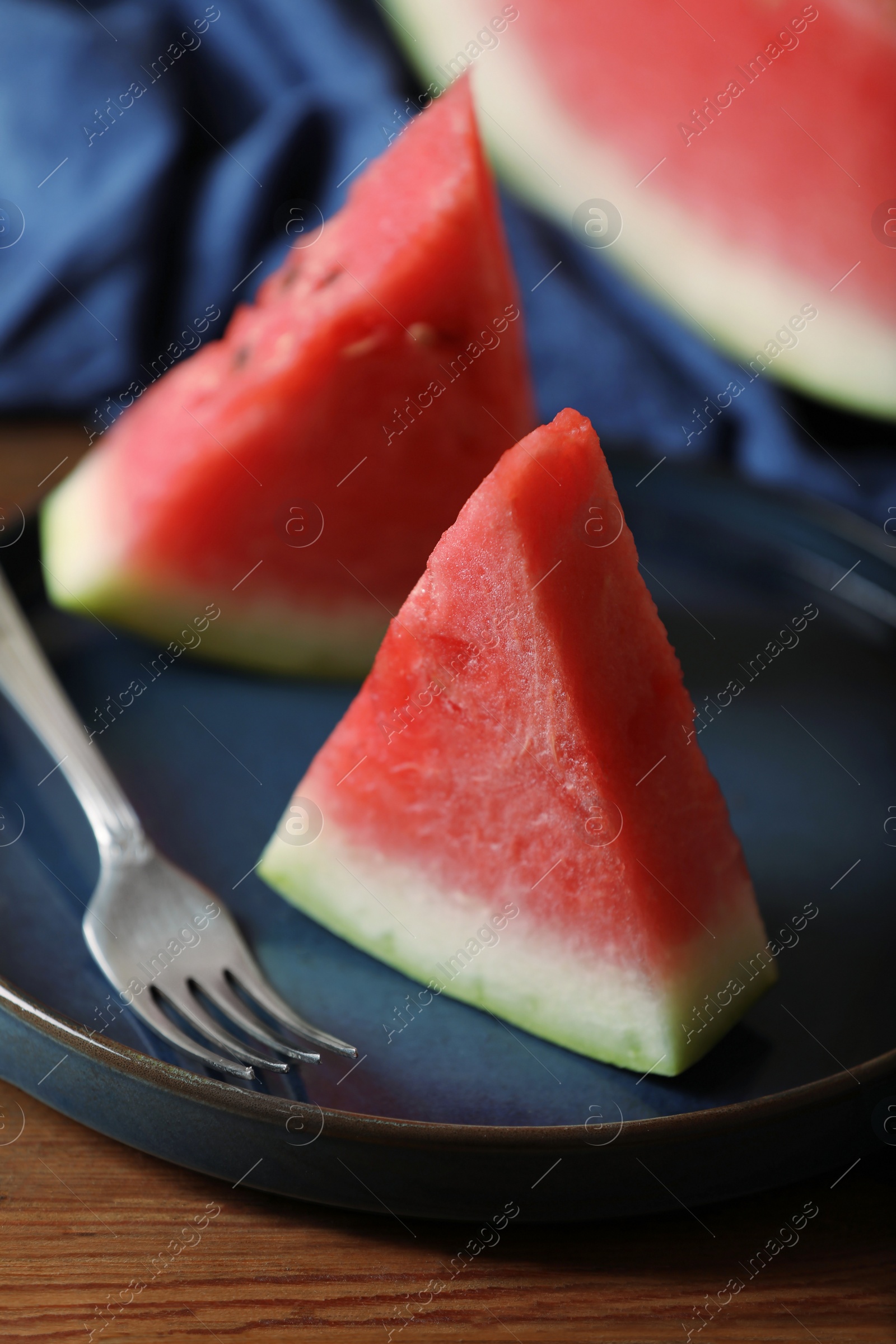 Photo of Sliced fresh juicy watermelon served on wooden table, closeup