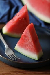 Photo of Sliced fresh juicy watermelon served on wooden table, closeup