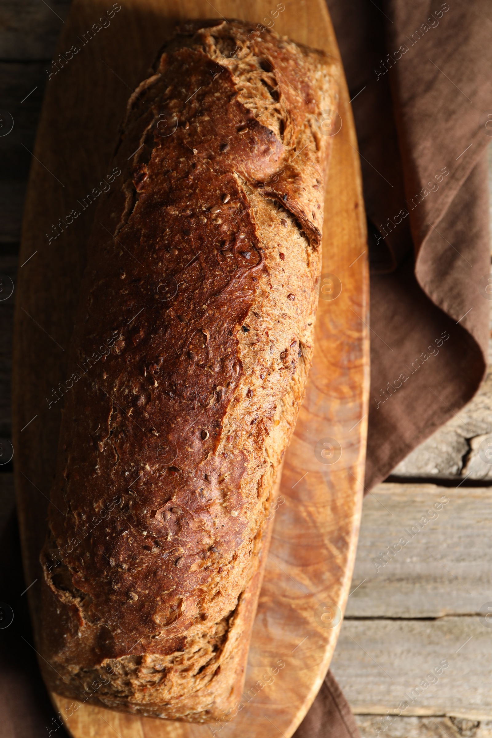 Photo of Freshly baked sourdough bread on wooden table, top view