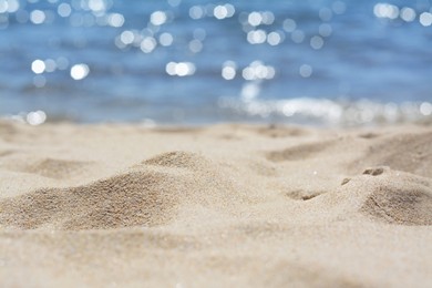 Photo of Sandy beach near sea on sunny day, closeup