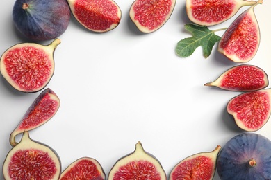 Photo of Flat lay composition with fresh ripe fig slices on white background. Space for text