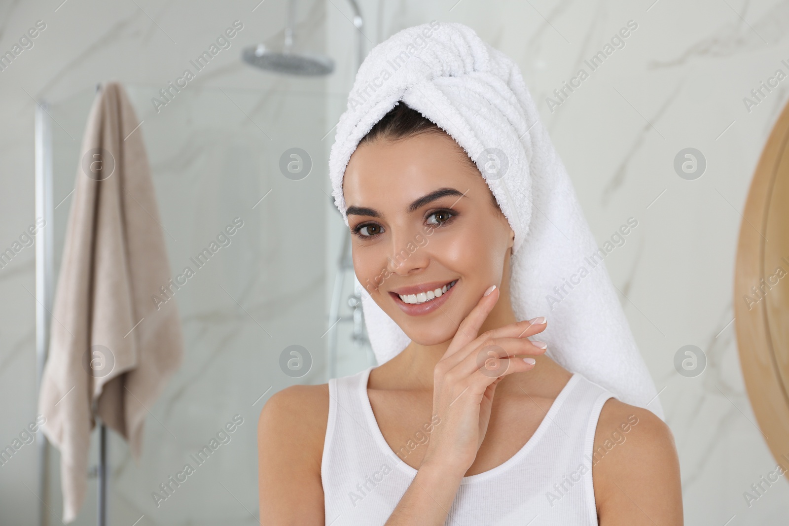 Photo of Happy young woman with clean skin in bathroom