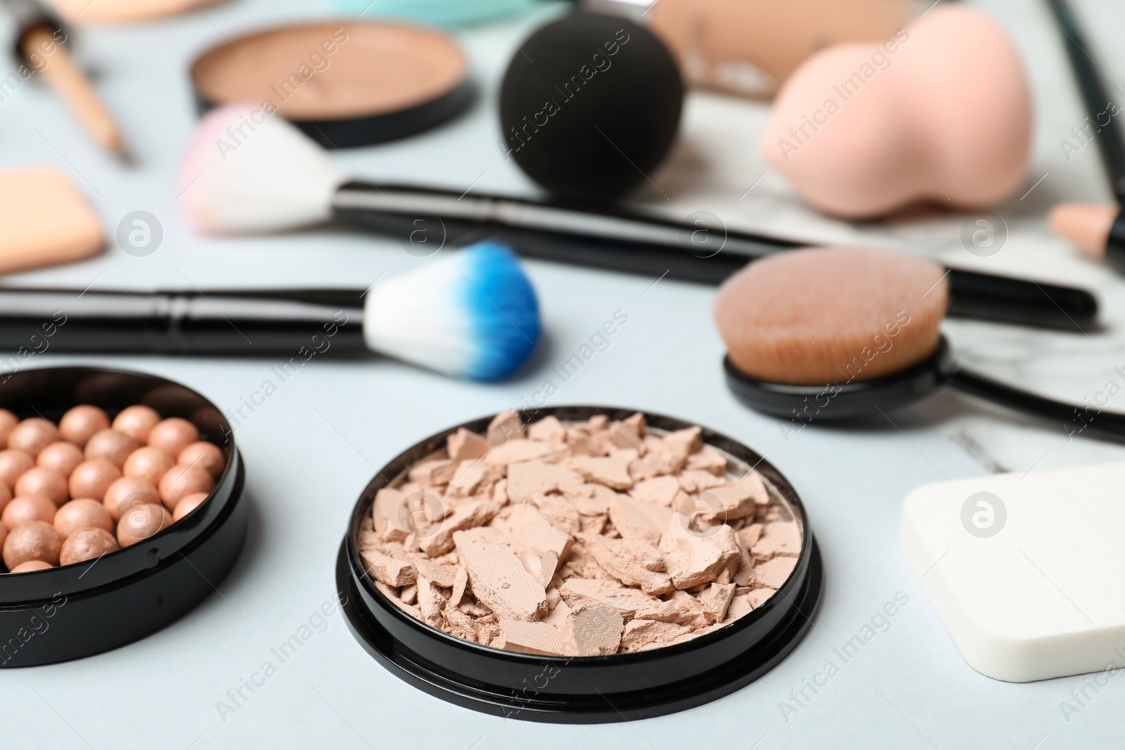 Photo of Composition with powder and beauty accessories on white background. Skin foundation