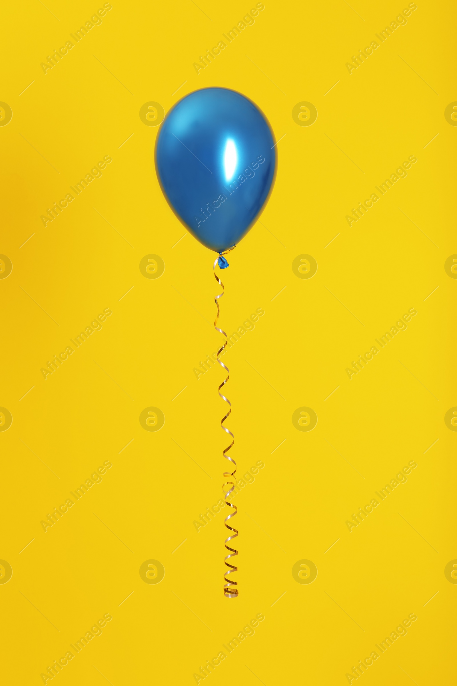 Photo of Bright balloon with ribbon on color background
