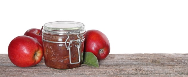 Delicious apple jam in jar and fresh fruits on wooden table against white background, space for text