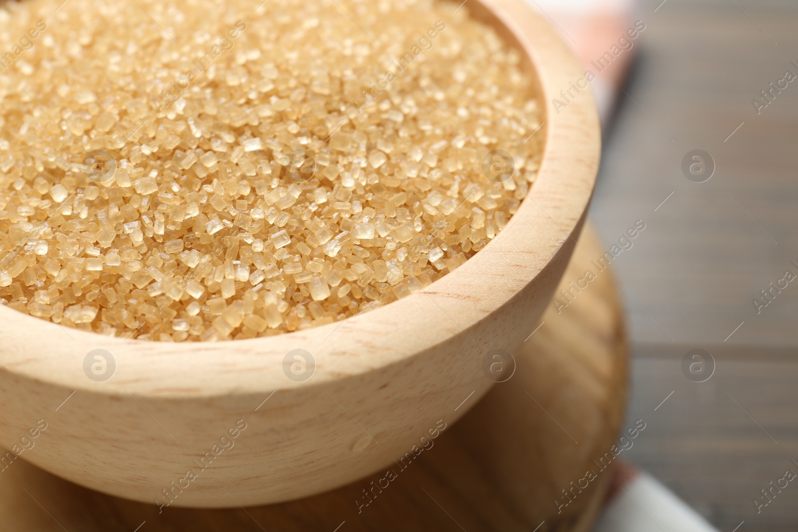 Photo of Brown sugar in bowl on table, closeup