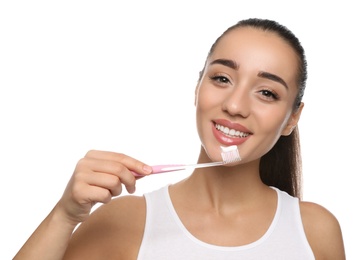 Photo of Woman holding toothbrush with paste on white background