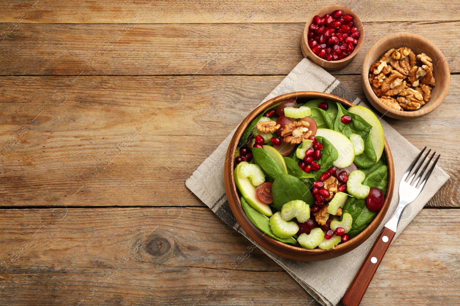 Photo of Delicious fresh celery salad served on wooden table, flat lay. Space for text