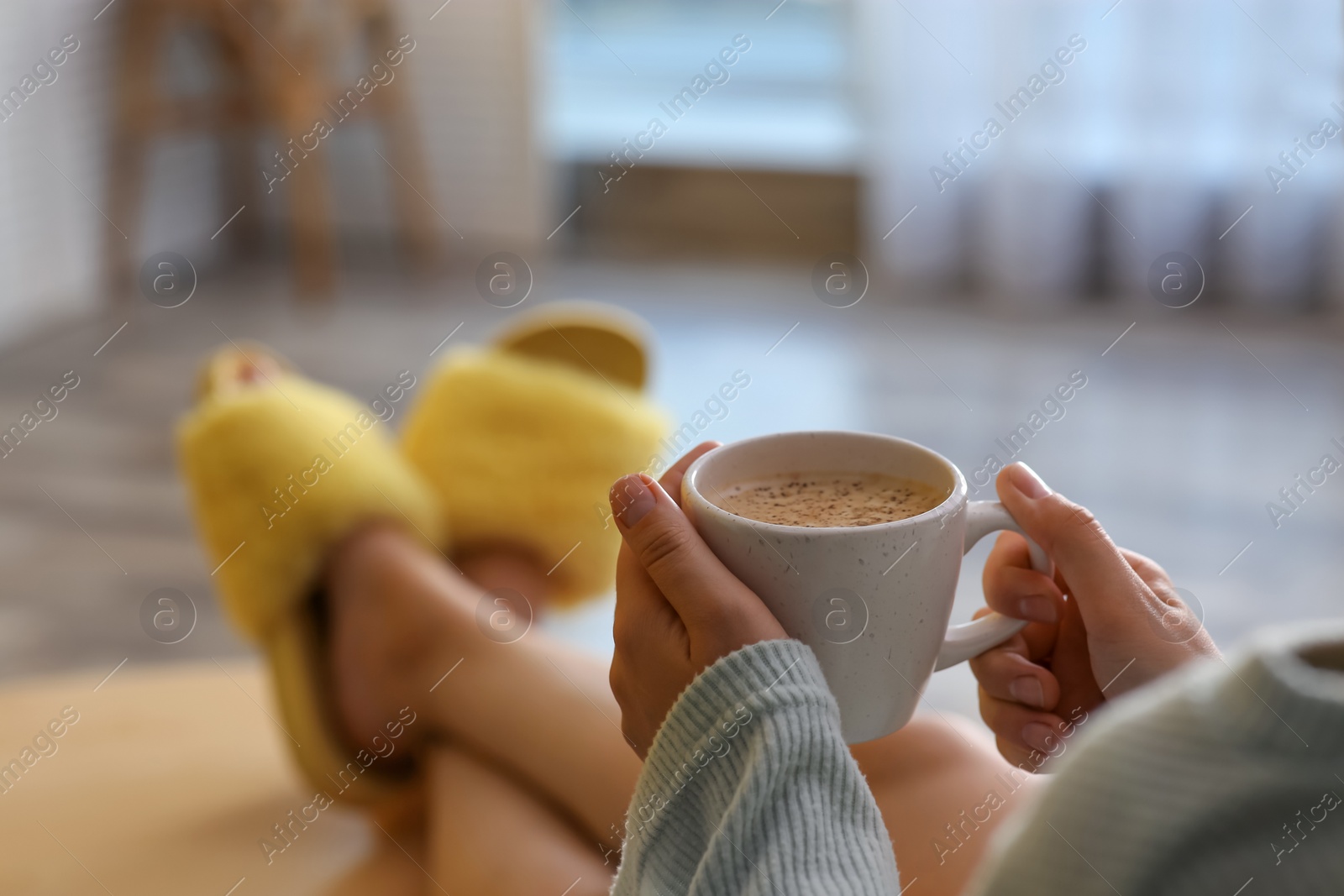 Photo of Woman with cup of aromatic coffee relaxing at home, closeup. Space for text