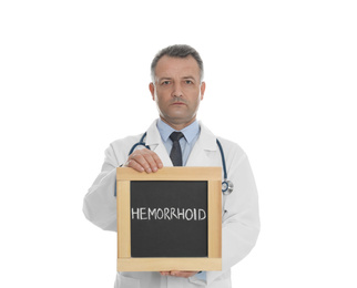 Photo of Doctor holding blackboard with word HEMORRHOID on white background