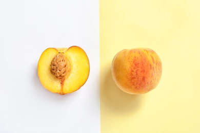 Flat lay composition with ripe peaches on color background