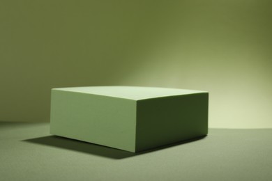 Presentation of product. Podium and shadows on light green background. Space for text