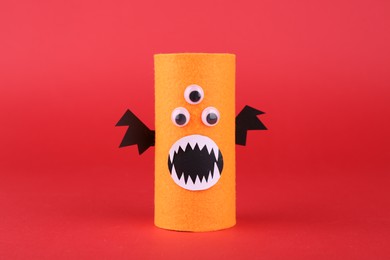 Photo of Spooky monster on red background. Handmade Halloween decoration