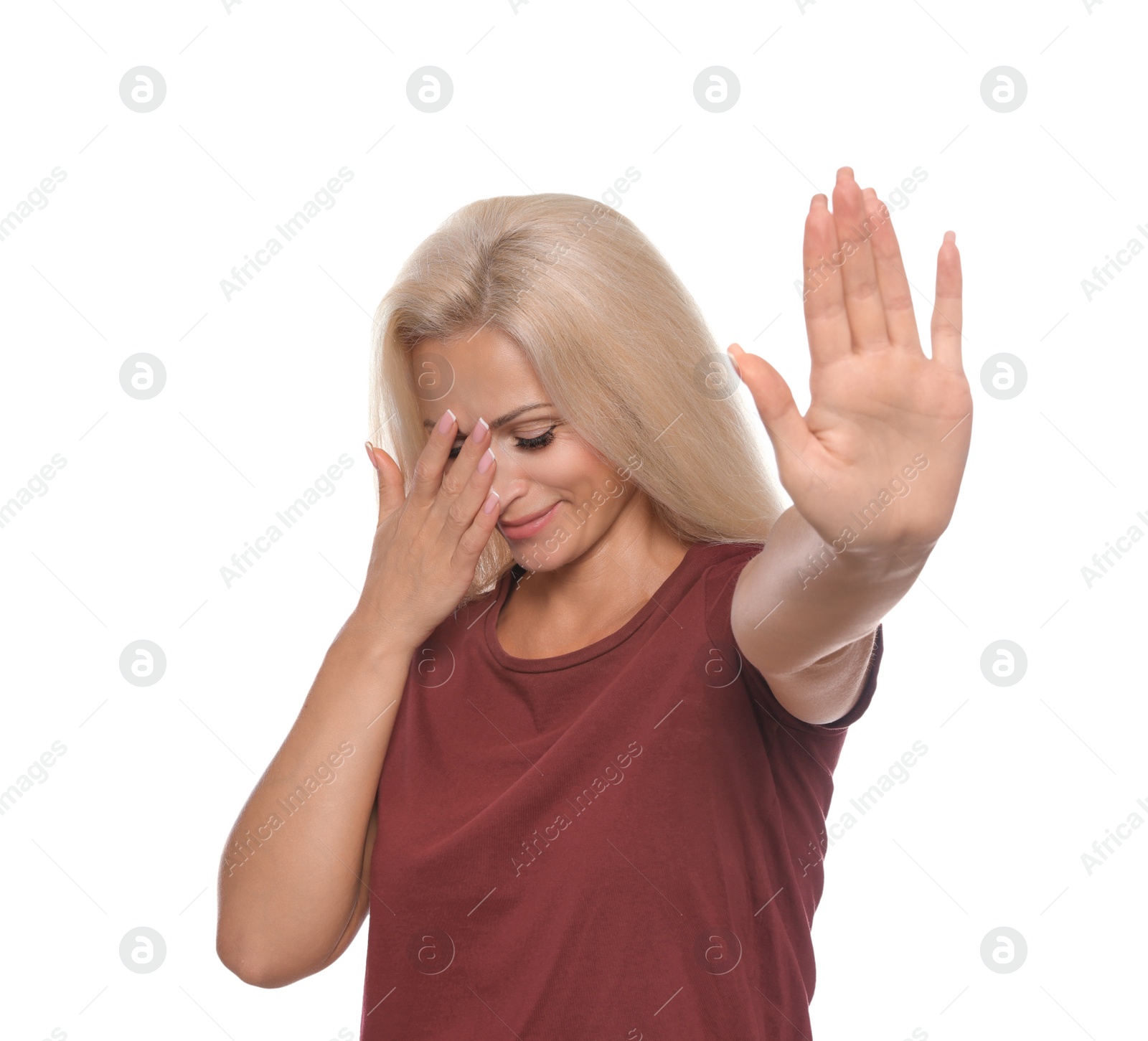 Photo of Embarrassed woman covering face with hand on white background