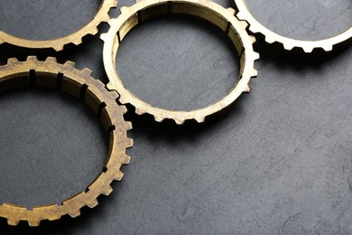 Photo of Stainless steel gears on grey background, closeup. Space for text