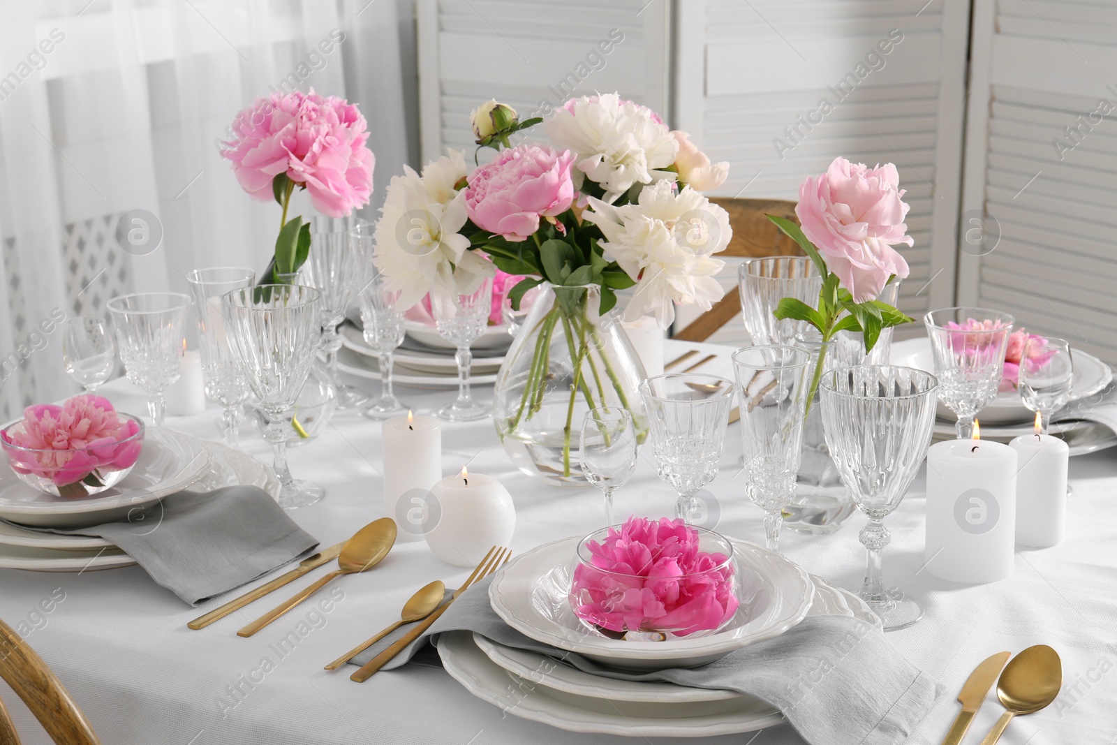 Photo of Stylish table setting with beautiful peonies in dining room