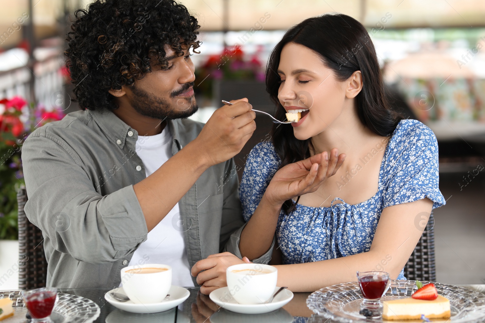 Photo of International dating. Happy couple spending time together in restaurant