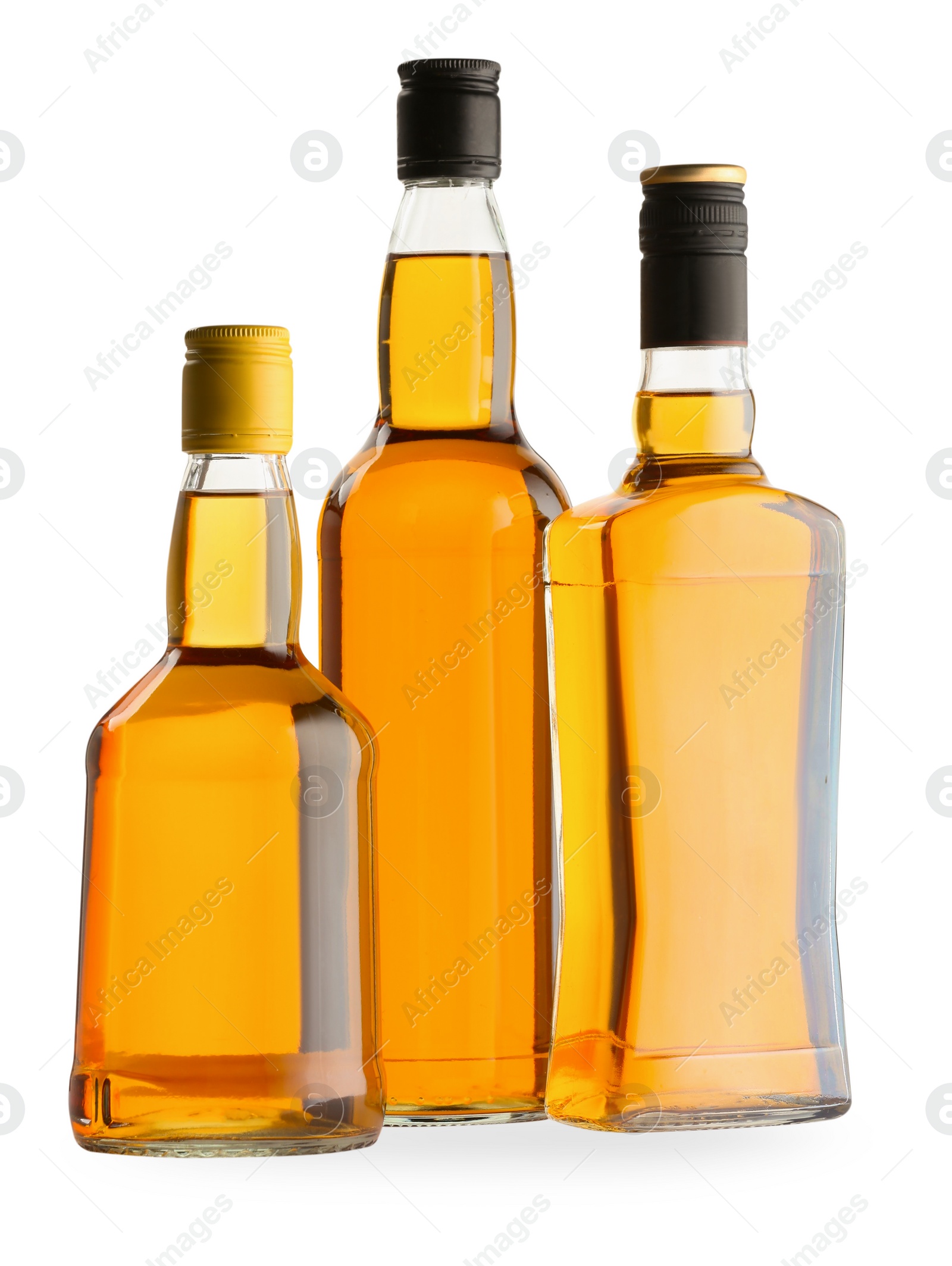 Photo of Different sorts of whiskey in glass bottles isolated on white