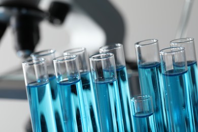 Photo of Test tubes with light blue liquid in laboratory, closeup