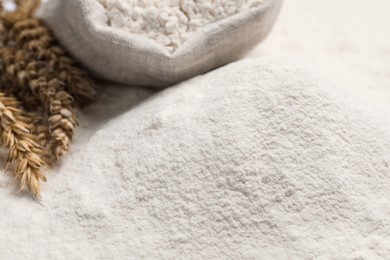 Photo of Spikes on wheat flour as background, closeup