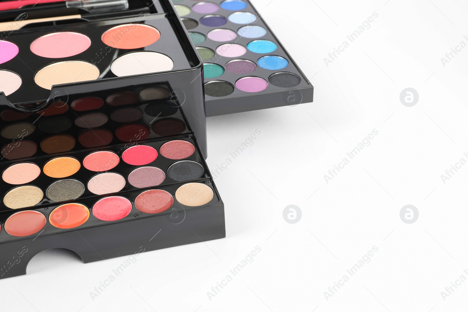 Photo of Large makeup case with different decorative cosmetics on white background