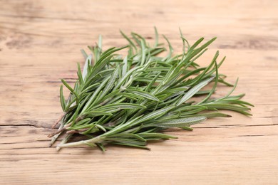 Sprigs of fresh rosemary on wooden table