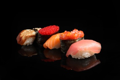 Photo of Delicious nigiri sushi on black background. Traditional Japanese cuisine