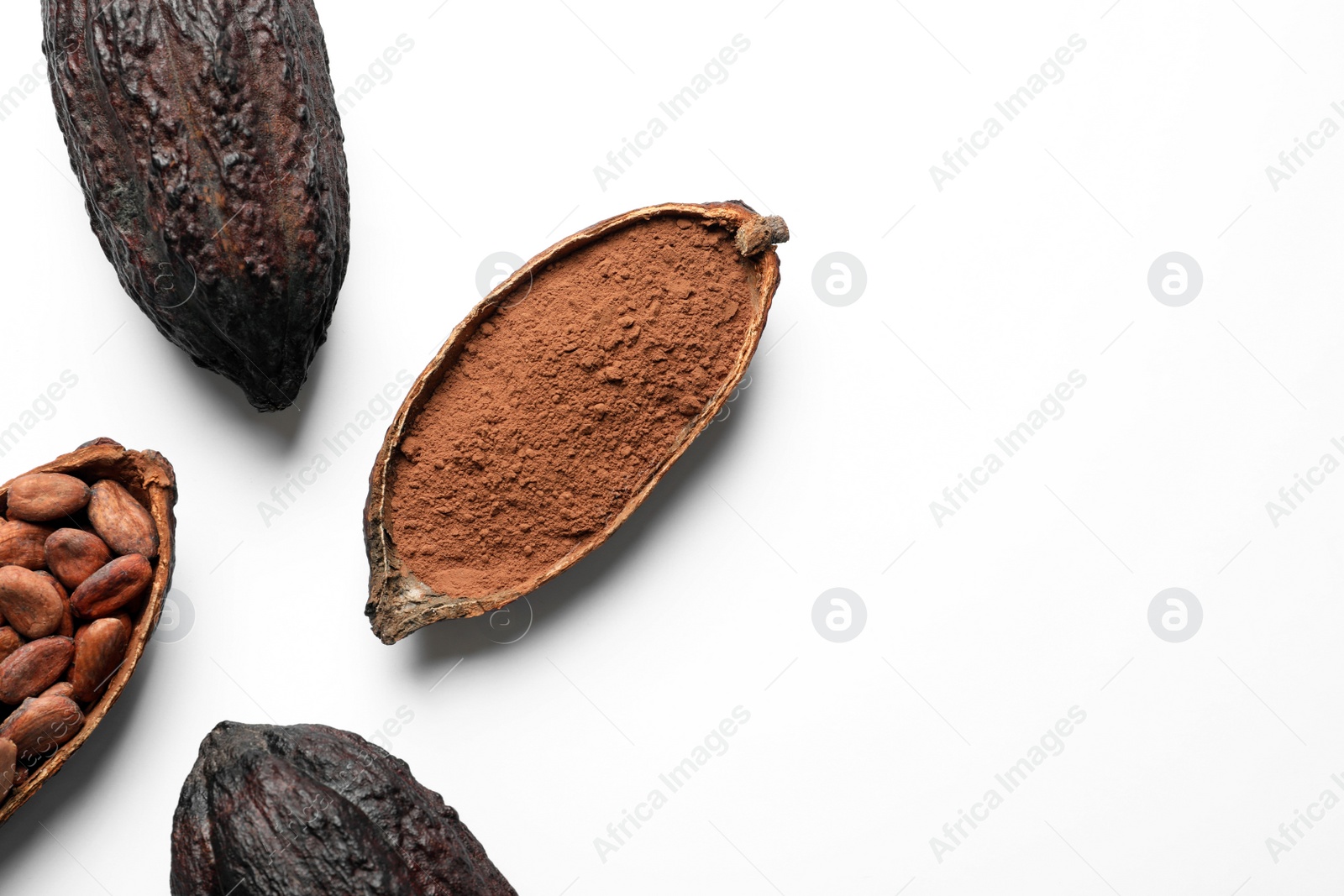 Photo of Cocoa pods with beans and powder on white background, top view