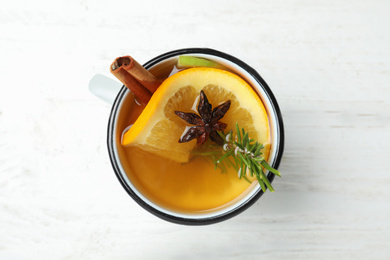 Aromatic white mulled wine on wooden table, top view