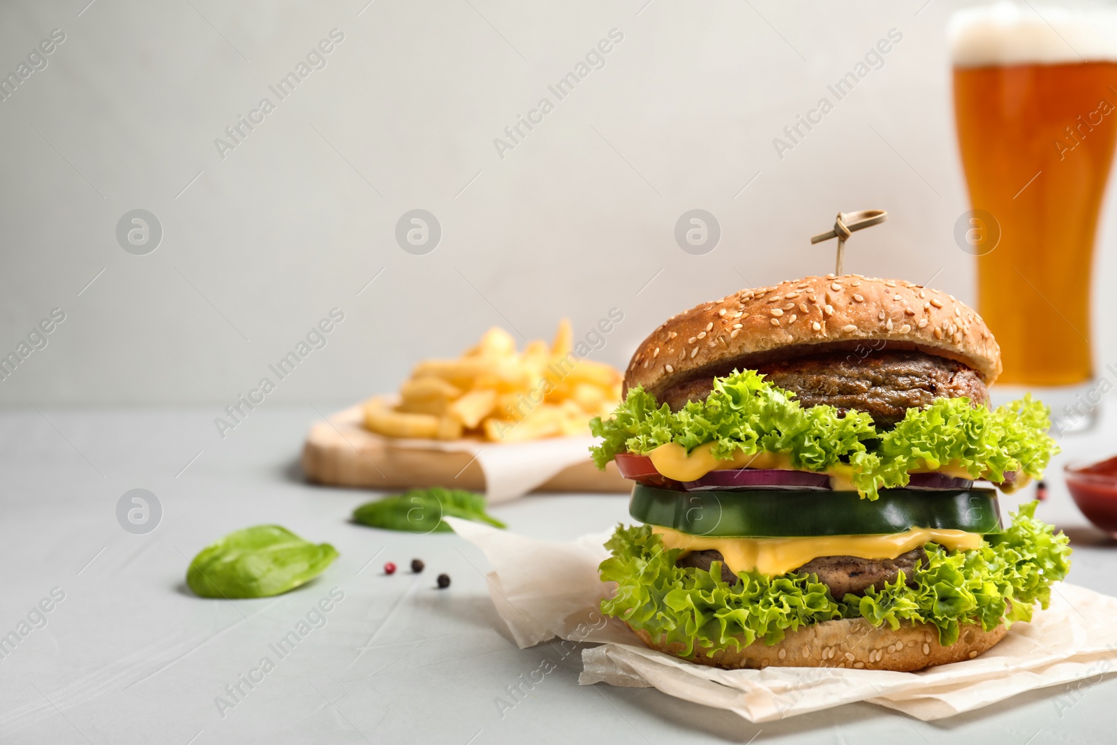 Photo of Tasty fresh burger on table. Space for text