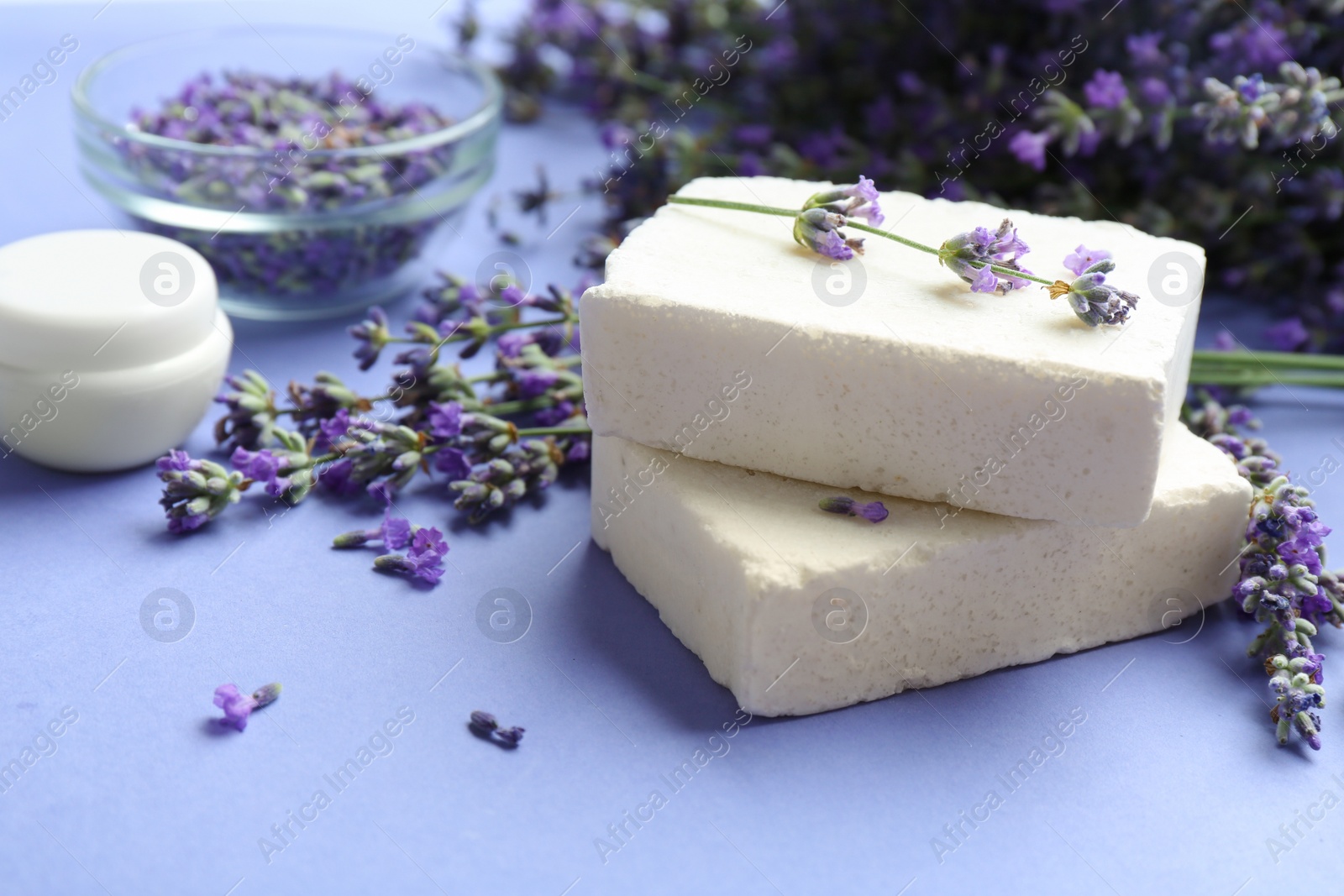 Photo of Hand made soap bars with lavender flowers on violet background