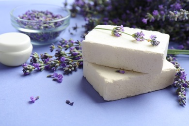 Photo of Hand made soap bars with lavender flowers on violet background
