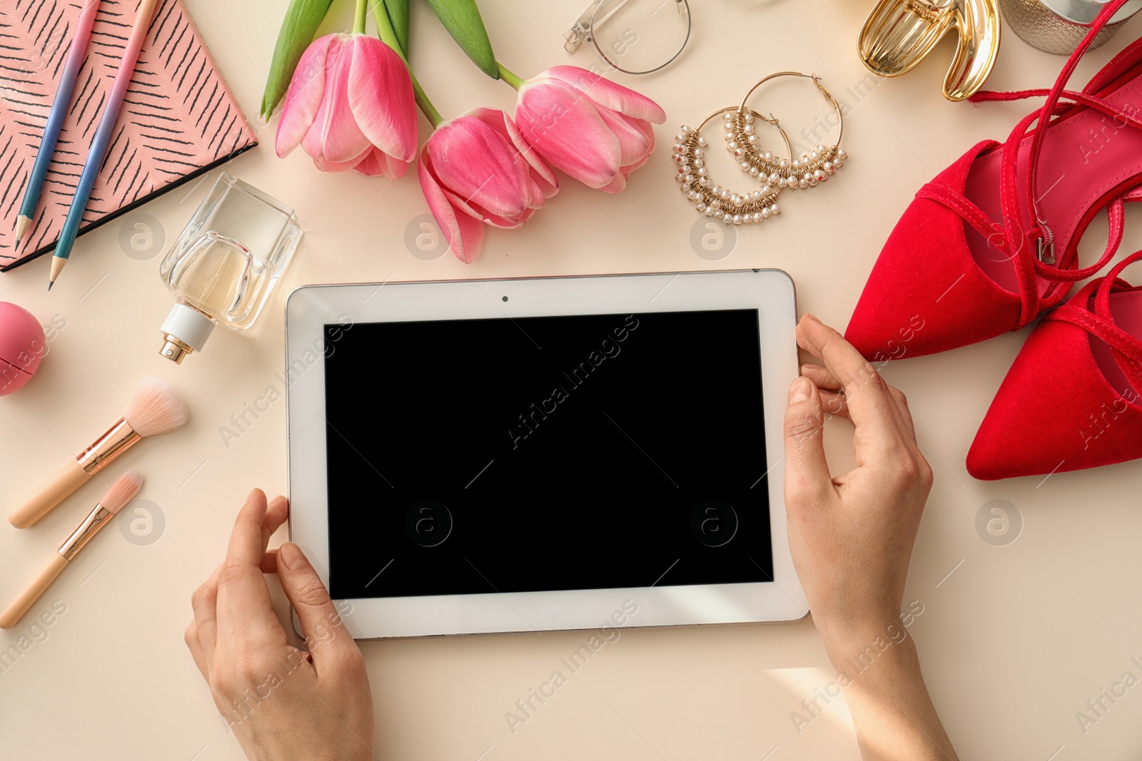 Photo of Beauty blogger with tablet at table, top view