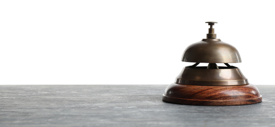 Hotel service bell on grey stone table against white background