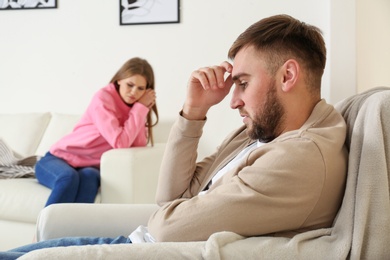 Young couple ignoring each other after argument in living room. Relationship problems