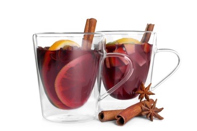 Photo of Cups with red mulled wine against white background