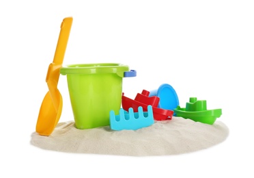 Photo of Plastic beach toys on pile of sand against white background