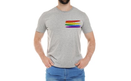 Image of Young man wearing grey t-shirt with image of LGBT pride flag on white background