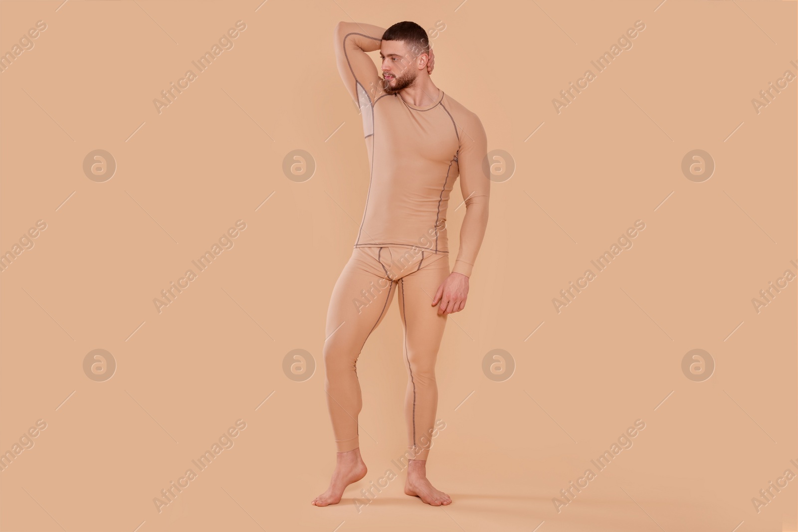 Photo of Man in warm thermal underwear on beige background