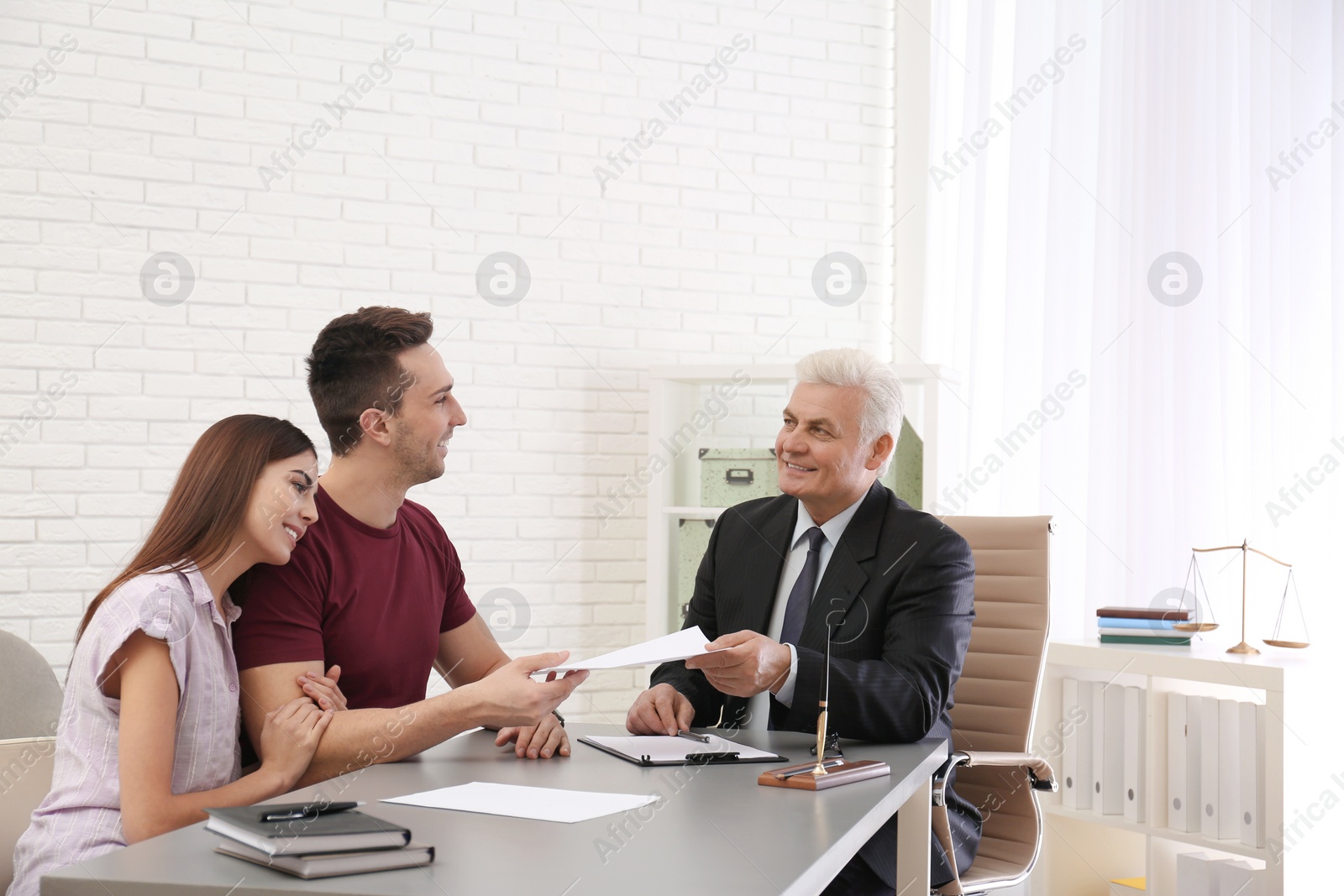 Photo of Lawyer having meeting with young couple in office