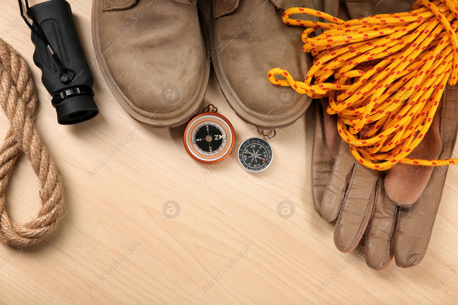 Photo of Flat lay composition with camping equipment on wooden background