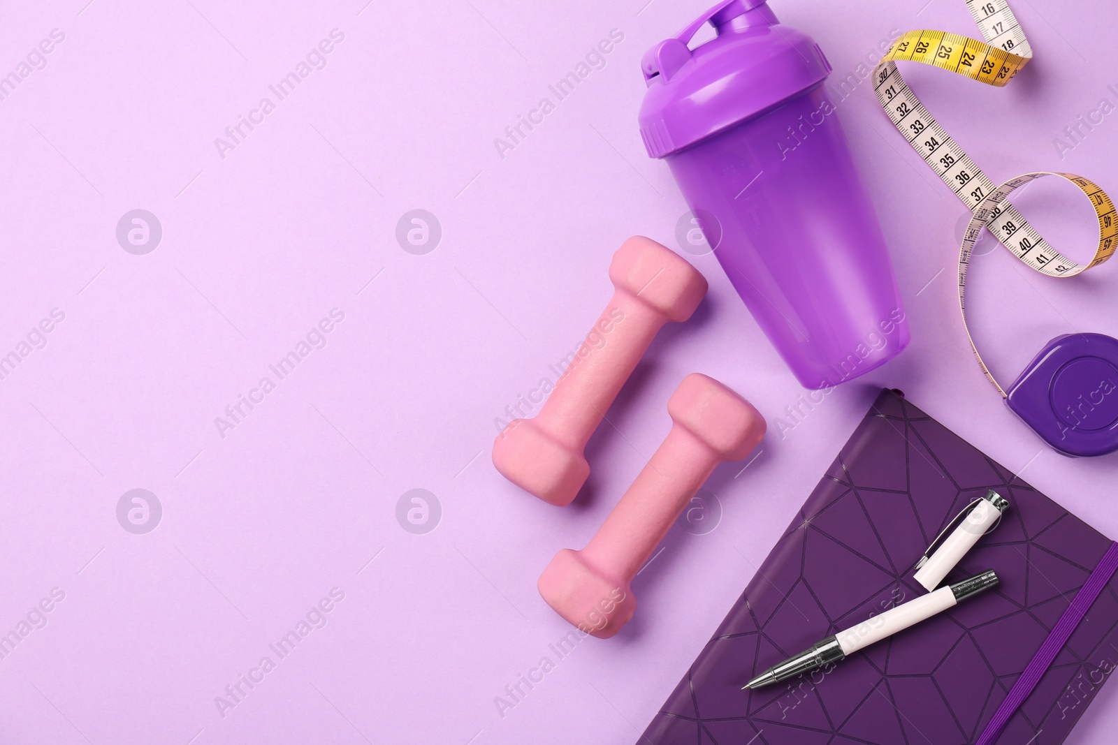 Photo of Flat lay composition with dumbbells on violet background, space for text