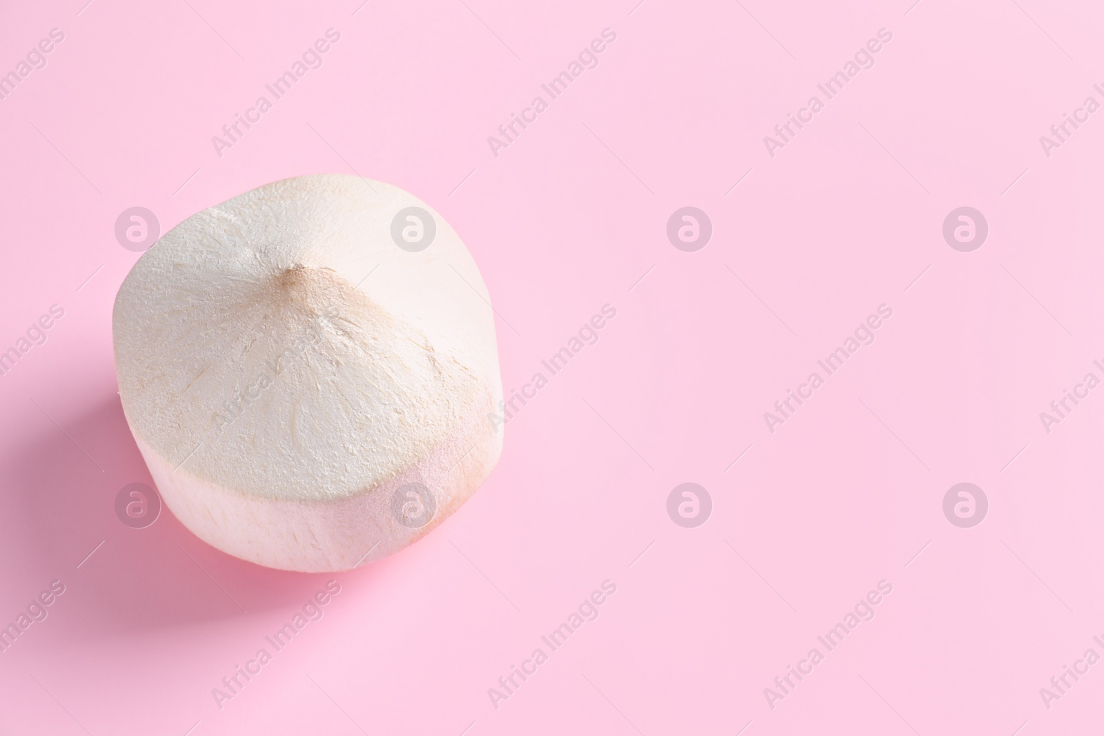Photo of Fresh peeled coconut on color background