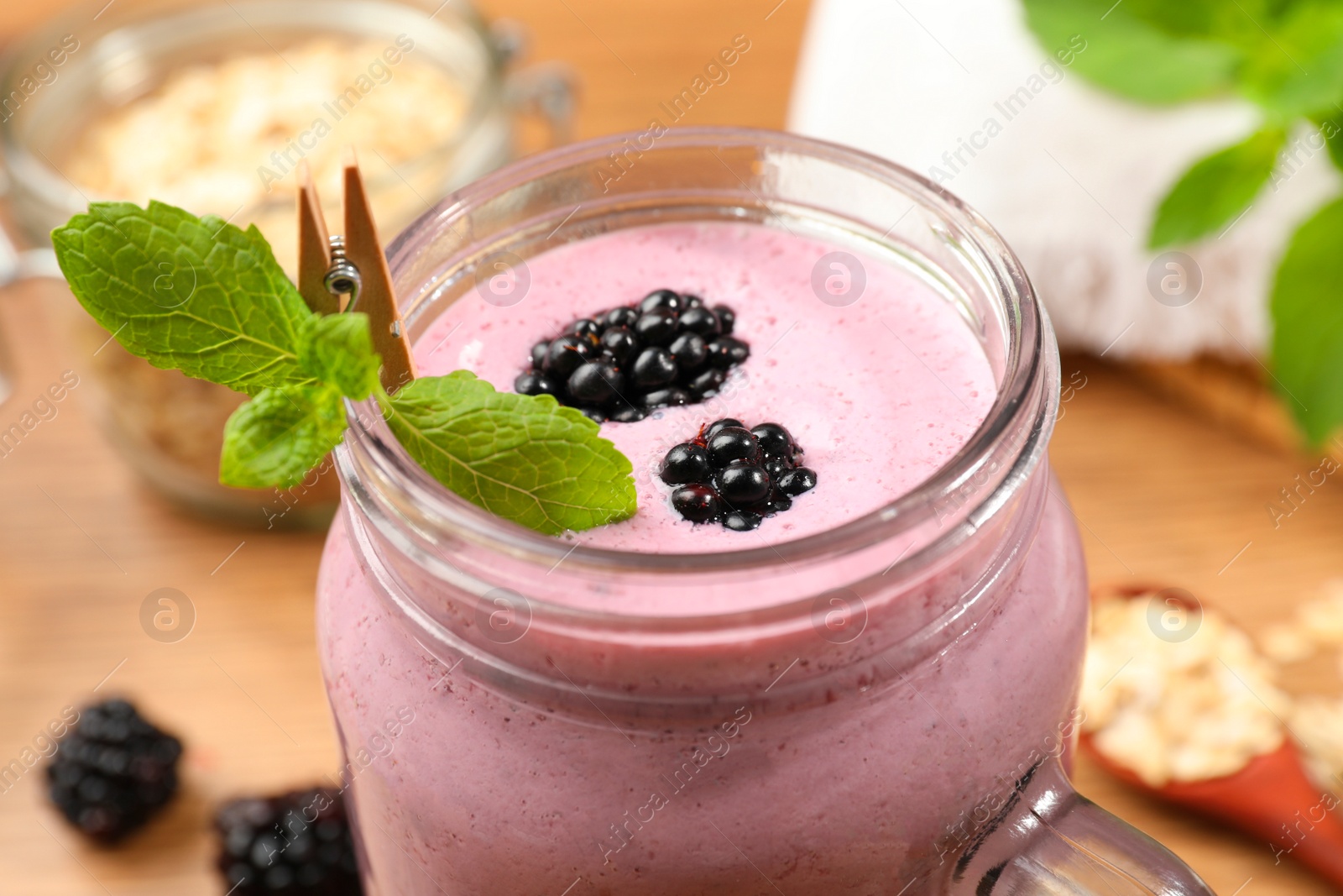 Photo of Delicious blackberry smoothie in mason jar, closeup