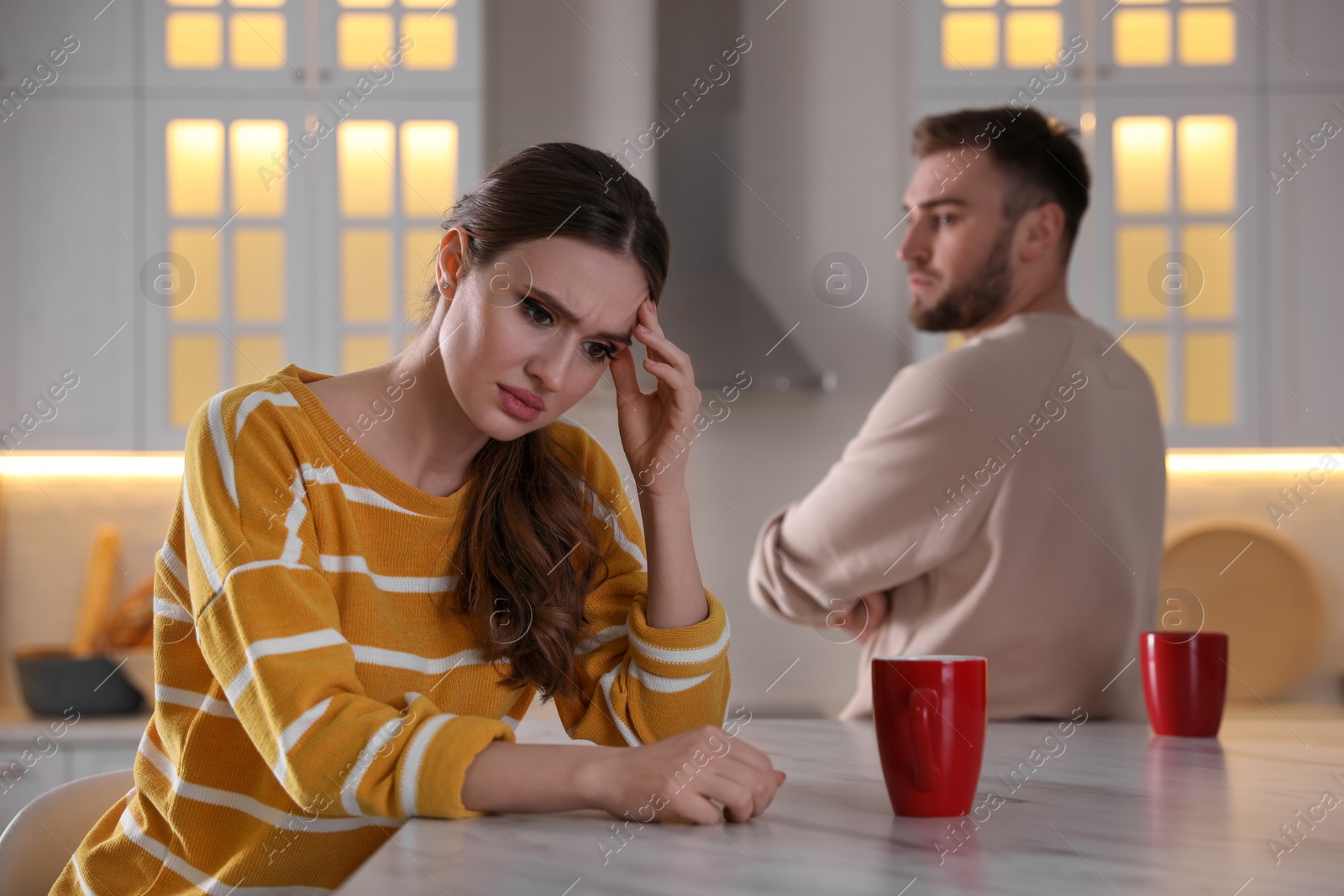 Photo of Young couple quarreling at home. Jealousy in relationship